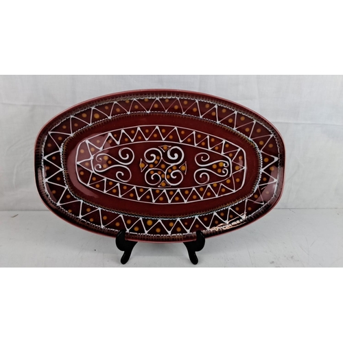 13 - Hand-painted ceramic platter signed Ty Breiz, featuring intricate geometric and scroll patterns in a... 