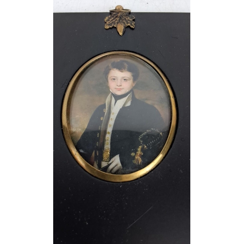 132 - Miniature print of a young boy in officer’s uniform, framed under glass with brass embellishments. O... 