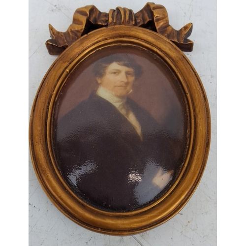 138 - Oval portrait miniature with a gold gilt frame and ribbon crest. Represents a gentleman in formal at... 