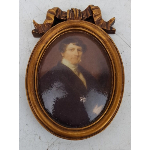 138 - Oval portrait miniature with a gold gilt frame and ribbon crest. Represents a gentleman in formal at... 