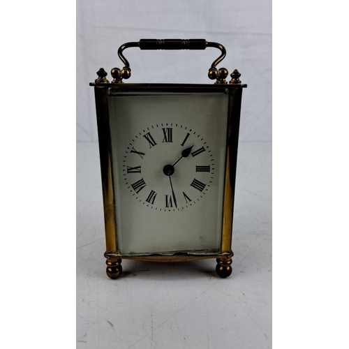 14 - Antique Brass carriage clock with Roman numeral dial and intricate handle, stamped 