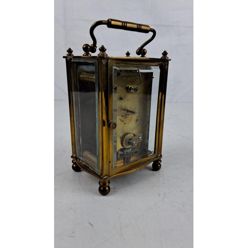 14 - Antique Brass carriage clock with Roman numeral dial and intricate handle, stamped 