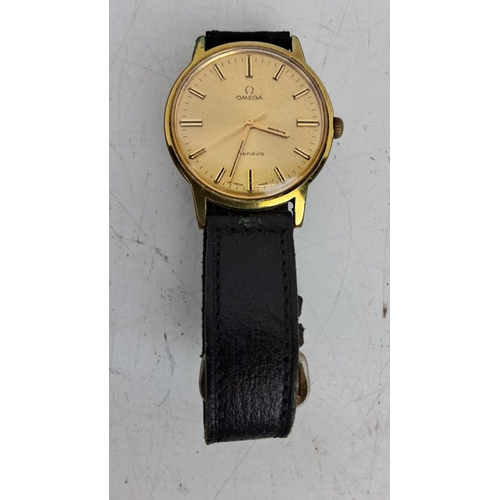 158 - Vintage Omega Genève wristwatch with a gold-tone case and a black leather strap. Comes with an origi... 