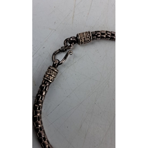 160 - Silver woven necklace with intricate clasp details, marked 