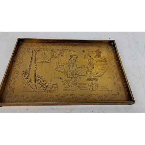 167 - Brass tray with engraved Asian scene depicting two women and a man by a tree, adorned with intricate... 