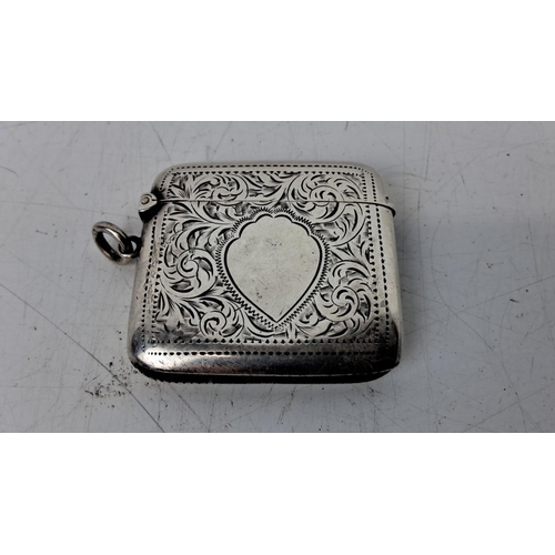 174 - Antique sterling silver vesta case with intricate floral engravings, flip-top lid, and loop attachme... 