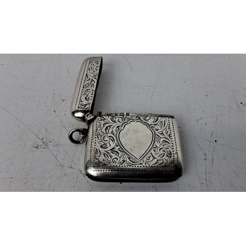 174 - Antique sterling silver vesta case with intricate floral engravings, flip-top lid, and loop attachme... 