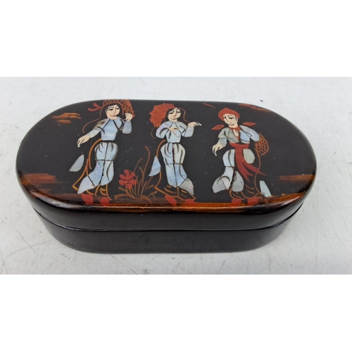 175 - A decorative jewellery box depicting traditional figures. It has a red velvet interior and a mirror ... 