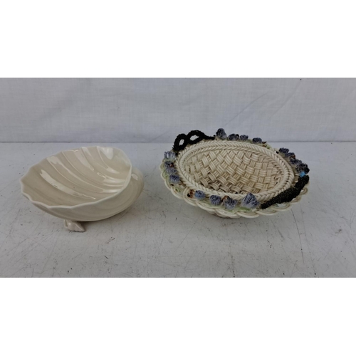 176 - A Belleek pottery shell-shaped bowl and similar style woven basket with blue flower accents, measuri... 