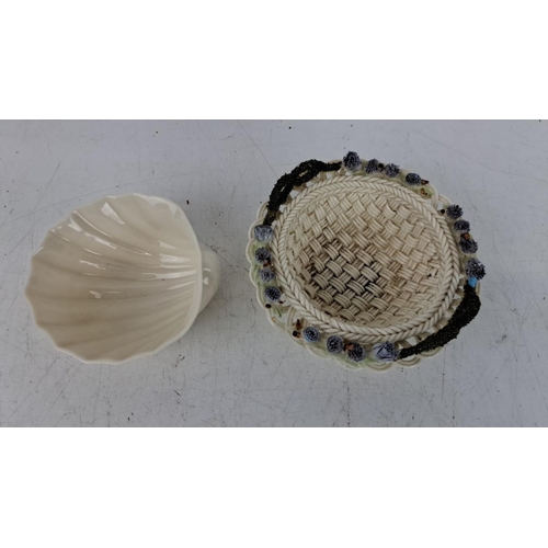 176 - A Belleek pottery shell-shaped bowl and similar style woven basket with blue flower accents, measuri... 