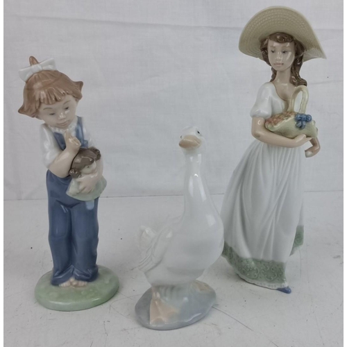 23 - Three NAO by Lladro porcelain figurines. Includes a girl with a doll, a woman with a basket, and a s... 