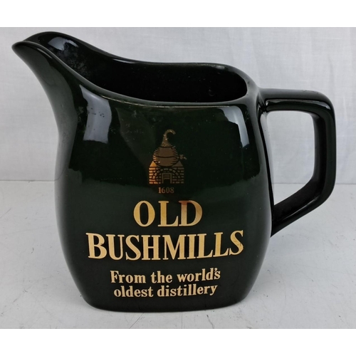 29 - Vintage 'Old Bushmills' ceramic whiskey jug, dark green with gold lettering, from the world's oldest... 