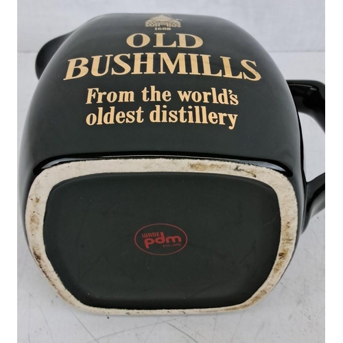 29 - Vintage 'Old Bushmills' ceramic whiskey jug, dark green with gold lettering, from the world's oldest... 