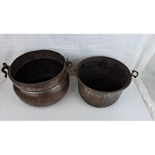 3 - Two antique copper cauldrons/plant pots with iron handles.