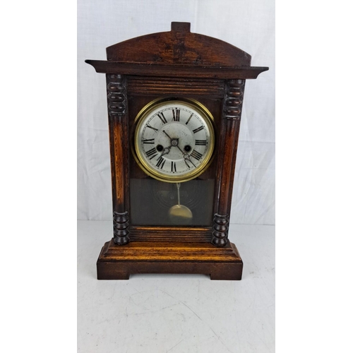 42 - Victorian wooden mantle clock with Roman numeral dial and brass bezels. Features glass front panel a... 