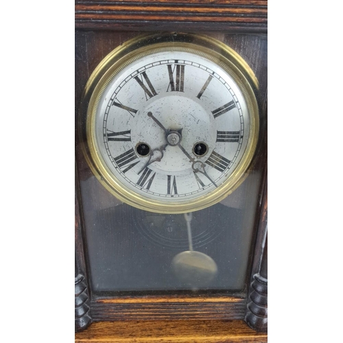 42 - Victorian wooden mantle clock with Roman numeral dial and brass bezels. Features glass front panel a... 