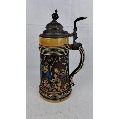 45 - German beer stein with a pewter lid, featuring a medieval tavern scene. It is marked with 