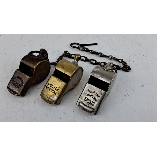 46 - Three vintage metal whistles, including 