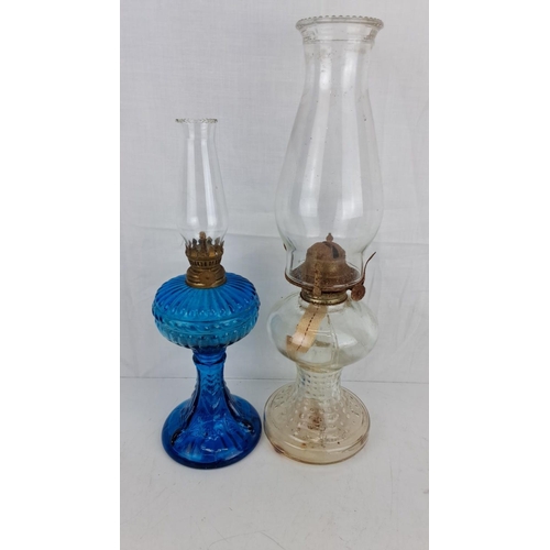 5 - Two antique glass oil lamps. One blue and one clear glass base with intricate detailing. Comes compl... 