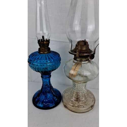 5 - Two antique glass oil lamps. One blue and one clear glass base with intricate detailing. Comes compl... 