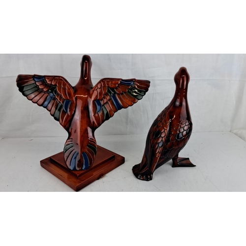 59 - Pair of handcrafted wooden duck sculptures with a glossy finish. They feature intricate feather deta... 