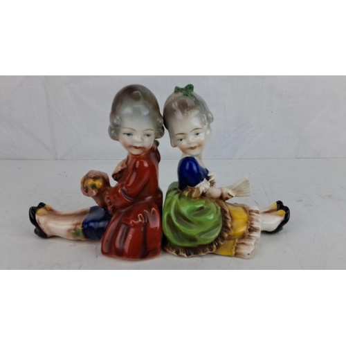 60 - Pair of hand-painted porcelain figurine bookends featuring a boy and girl in 18th-century attire, ma... 