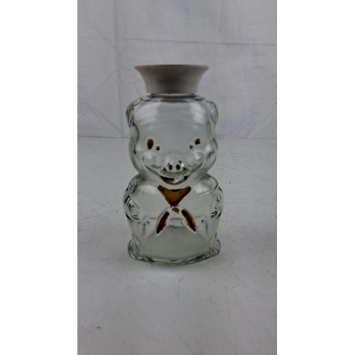 61 - Vintage glass piggy bank with a removable white cap and brown painted details.