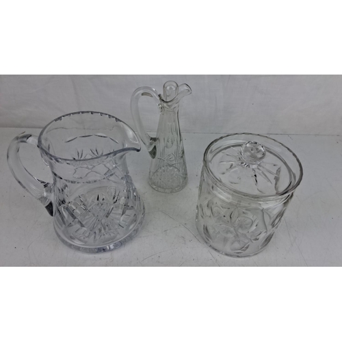 65 - Three-piece cut glass set, including a pitcher, a carafe, and a lidded biscuit jar, all detailed wit... 