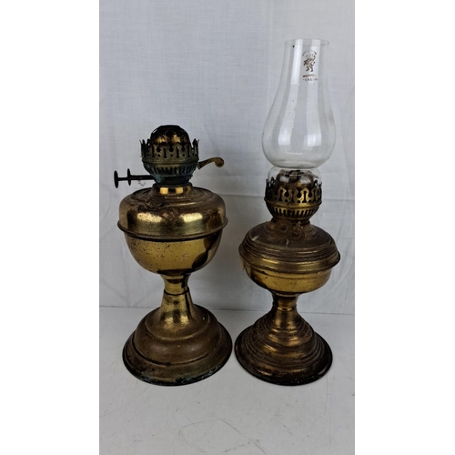 7 - Two vintage brass oil lamps with intricate wick adjustment mechanisms and chimney holders. One is ma... 