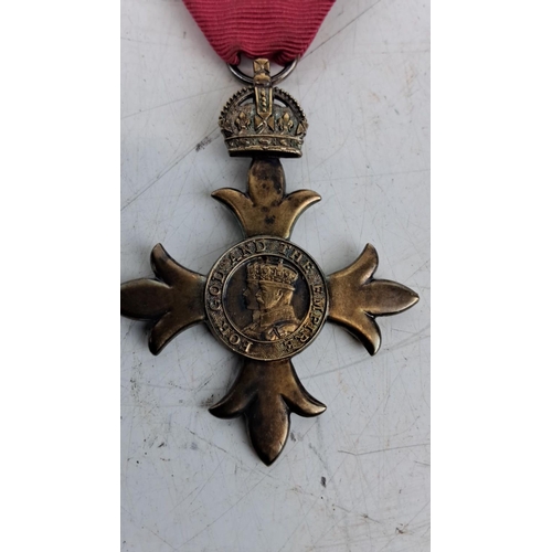 71 - Antique British Order of the British Empire (OBE) medal. Contains a central coin with a crowned mona... 