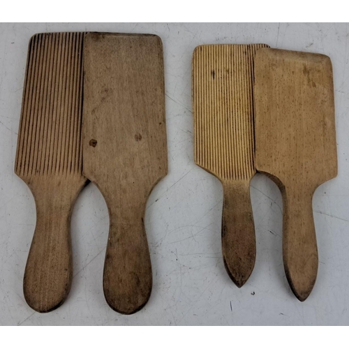 73 - Four vintage wooden butter paddles, each with a grooved and smooth side.