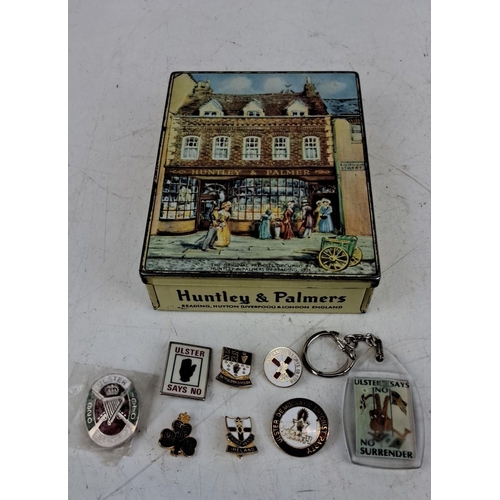 80 - Vintage Huntley & Palmers biscuit tin with a collection of 7 Ulster-themed enamel badges and a simil... 