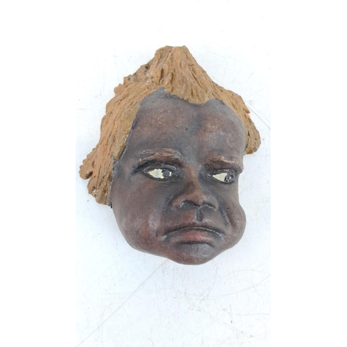 89 - Terracotta wall plaque featuring a child's face. Signed 