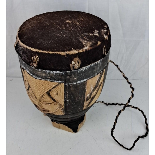 9 - African tribal drum, hand-carved wood with animal hide drumhead, decorated with mask motifs.