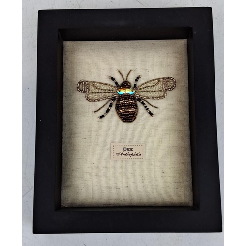 92 - Framed textile artwork depicting a bee, labeled 