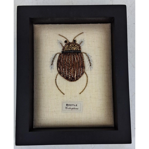 96 - Framed fabric artwork featuring a handcrafted beaded beetle labeled 