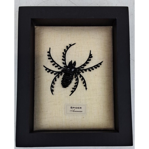 98 - Framed beaded spider artwork with intricate black beadwork on a linen fabric background, encased in ... 