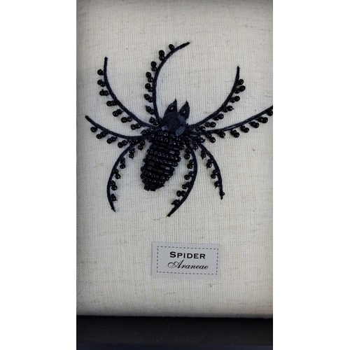 98 - Framed beaded spider artwork with intricate black beadwork on a linen fabric background, encased in ... 