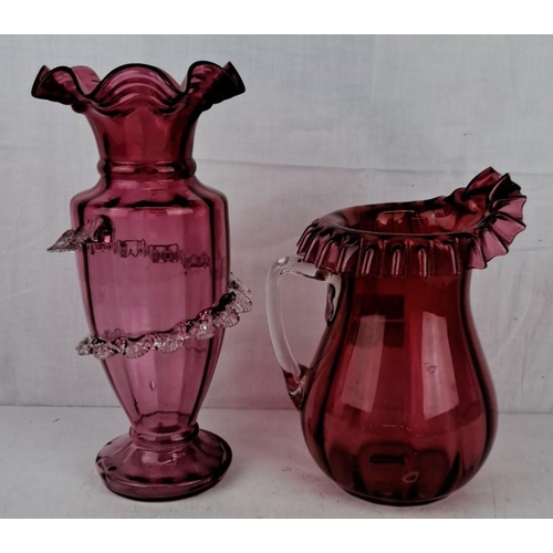 185 - Pair of vintage cranberry glass pieces, including a ruffled-edge pitcher and a vase with clear glass... 