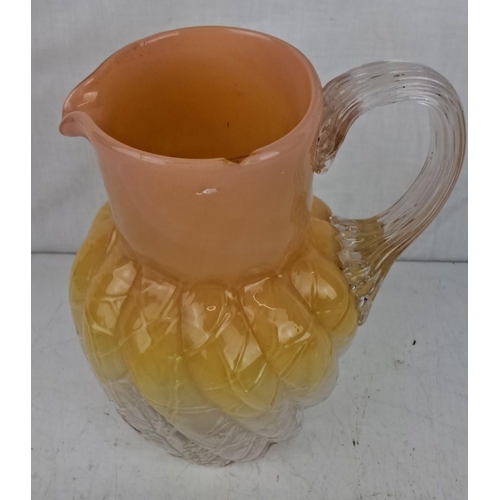 189 - Vintage ombre glass pitcher in orange, yellow, and clear hues. The jug features a textured body with... 