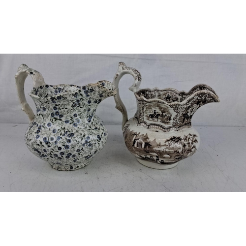 202 - Pair of 19th-century transferware pitchers. One has a floral 'Forget Me Not' design in blue and whit... 