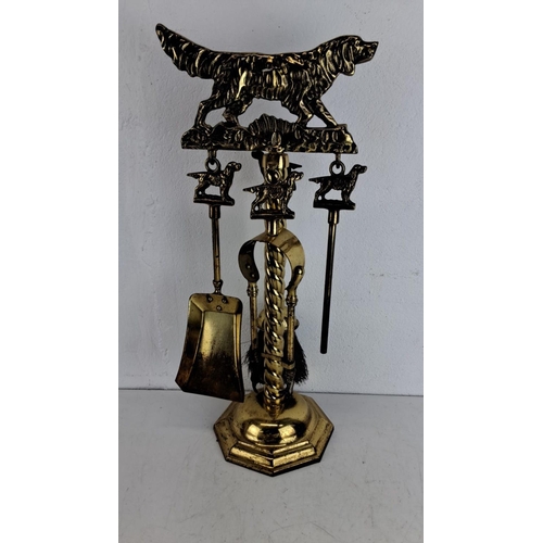 212 - Victorian brass fireplace set featuring a dog motif. Includes shovel, poker, brush, and stand. Detai... 