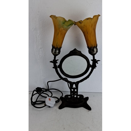 218 - Double-lamp vanity mirror in Art Nouveau style. Features an ornate bronze base and delicate yellow g... 