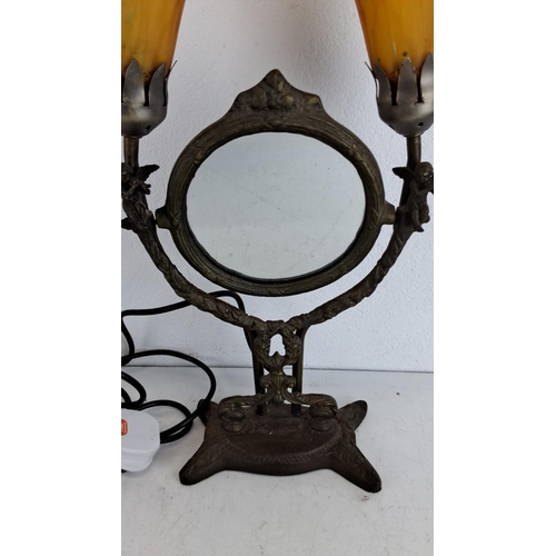 218 - Double-lamp vanity mirror in Art Nouveau style. Features an ornate bronze base and delicate yellow g... 