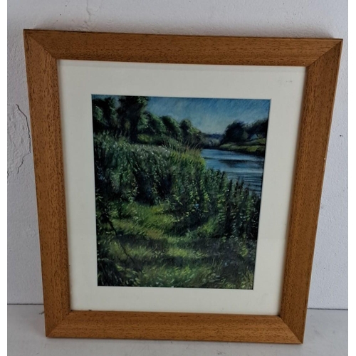 219 - Framed landscape painting depicting a  riverside scene with lush greenery, created with soft pastels... 