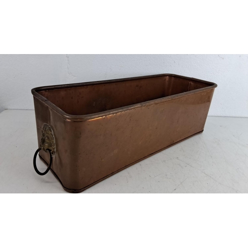 220 - Vintage rectangular copper planter featuring lion head handles on two sides. Measuring 40cm in width... 