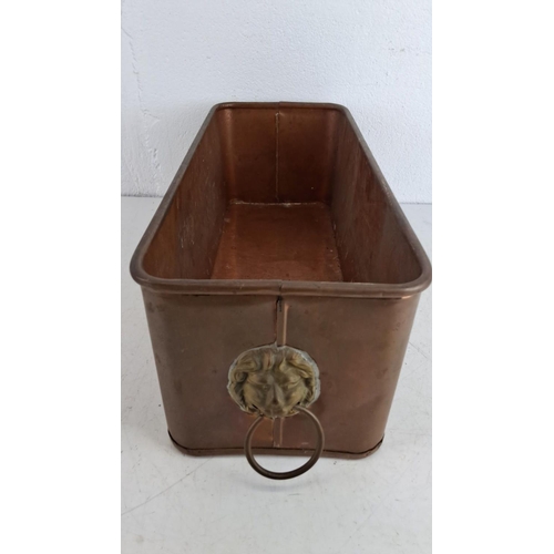 220 - Vintage rectangular copper planter featuring lion head handles on two sides. Measuring 40cm in width... 