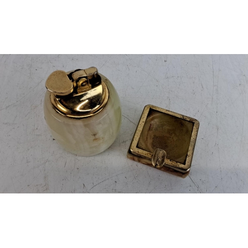 224 - Vintage onyx lighter and matching ashtray set with brass accents. 1950s design, combining natural st... 