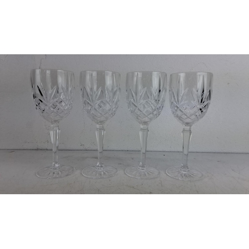 227 - Set of four crystal cut glass stemware with intricate geometric patterns.