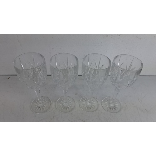 227 - Set of four crystal cut glass stemware with intricate geometric patterns.